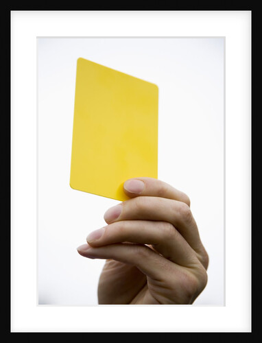 Hand holding yellow card by Anonymous