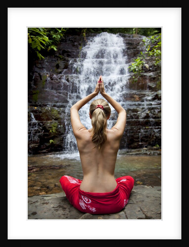 Woman meditating in front of a waterfall by Anonymous