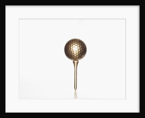 Gold golf ball and tee by Anonymous
