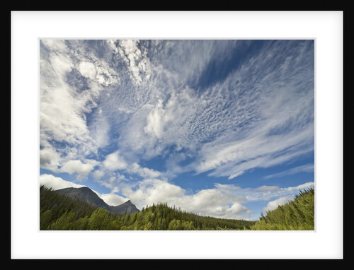 Cumulus and cirrus clouds above mountains by Anonymous