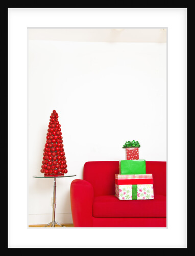 Stack of Christmas gifts on sofa by Anonymous