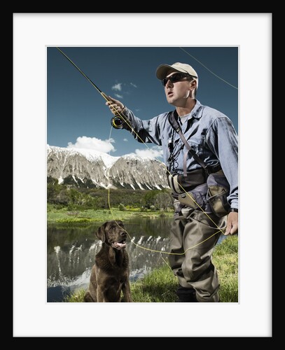 Man fly fishing with dog by Anonymous