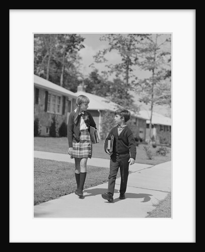 Boy girl carrying books walking to school in suburban neighborhood by Anonymous