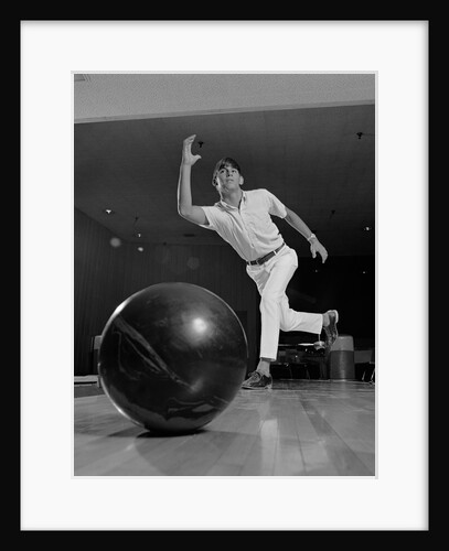 Young man having just thrown a bowling ball by Anonymous