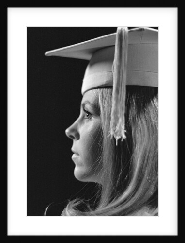 Profile blond female graduate wearing white mortarboard by Anonymous