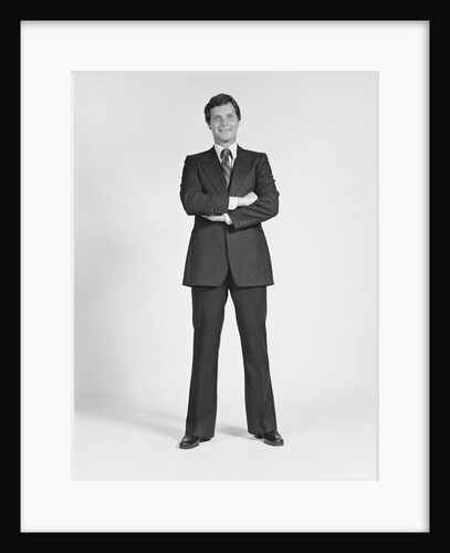 Smiling man standing wearing business suit by Anonymous