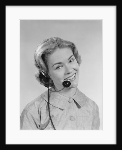 Smiling woman telephone operator wearing headset by Anonymous