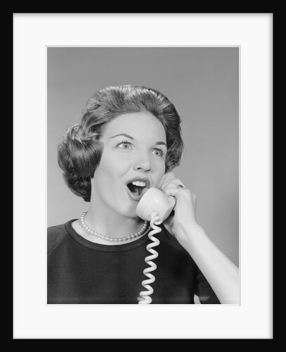 Excited woman talking on telephone by Anonymous