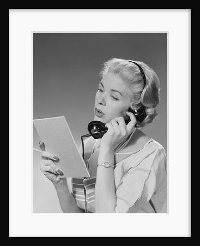 Blond woman talking on telephone reading list by Anonymous