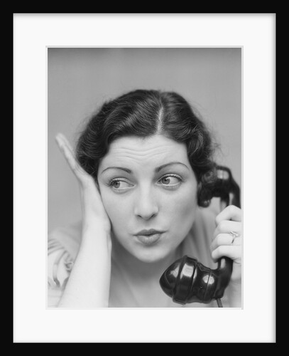 Young brunette woman with surprised expression hand to head talking on telephone by Anonymous