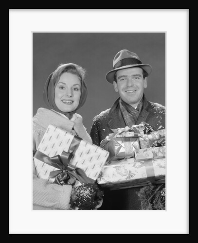 Couple man and woman holding wrapped christmas presents and packages by Anonymous