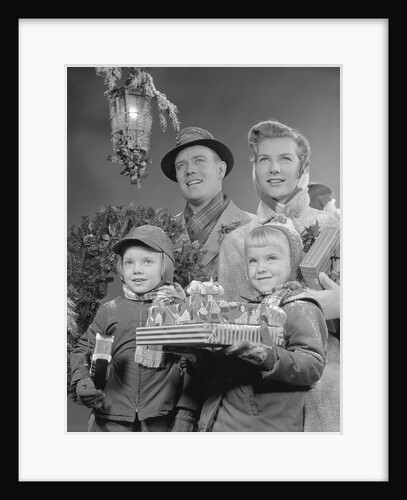 Family by lantern carrying wrapped christmas presents by Anonymous