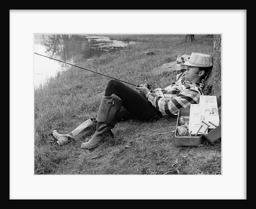 Man sleeping against a tree trunk while fishing in a lake by Anonymous