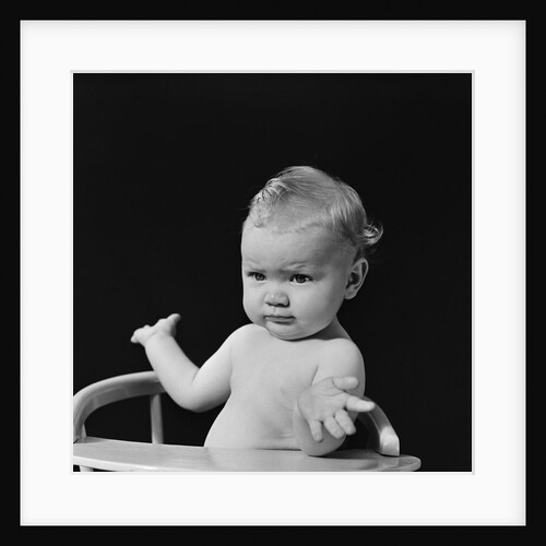 Baby in high chair making shrugging gesture by Anonymous