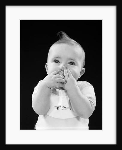 Portrait of baby covering mouth with hands fingers by Anonymous