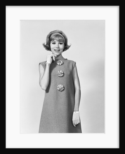 Smiling stylish young woman wearing sack dress gloves by Anonymous