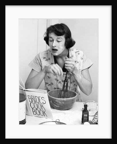 Woman face covered flour mixing ingredients reading brides cook book by Anonymous