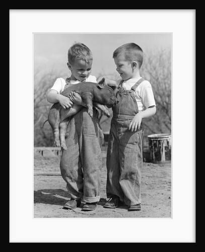 Boys in striped overalls holding piglet by Anonymous