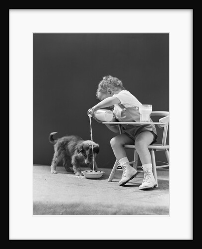 Toddler sitting in chair pouring milk from bottle into bowl for puppy dog by Anonymous