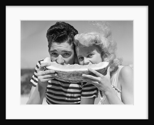 Teen age boy & girl eating slice watermelon by Anonymous