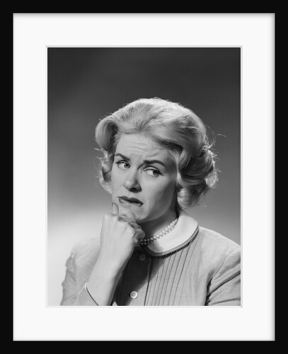Blonde woman fist to chin worried serious facial expression by Anonymous