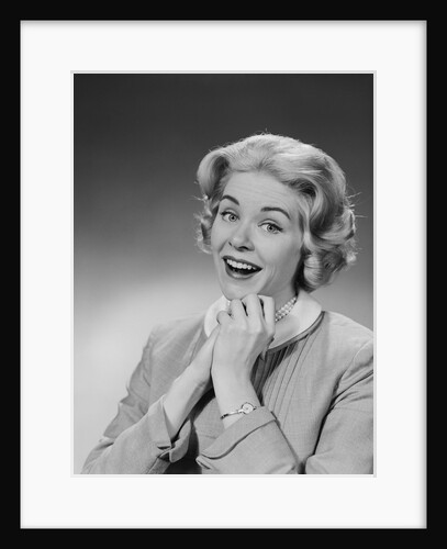 Woman clasped hand by chin with wishful hoping happy joyful facial expression by Anonymous