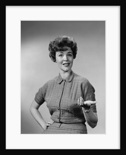 Brunette woman knit dress offhand gesture serious expression by Anonymous