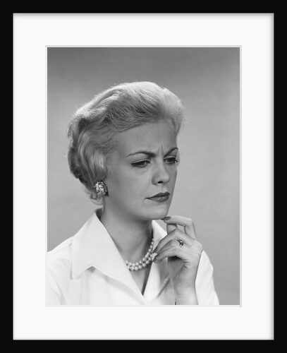 Blond woman pearl necklace worried concerned facial expression by Anonymous