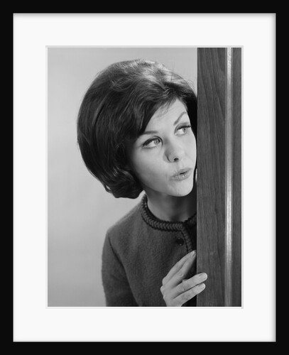 Brunette woman peeking around corner by Anonymous