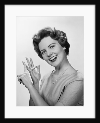 Smiling woman counting on fingers wearing pearls by Anonymous