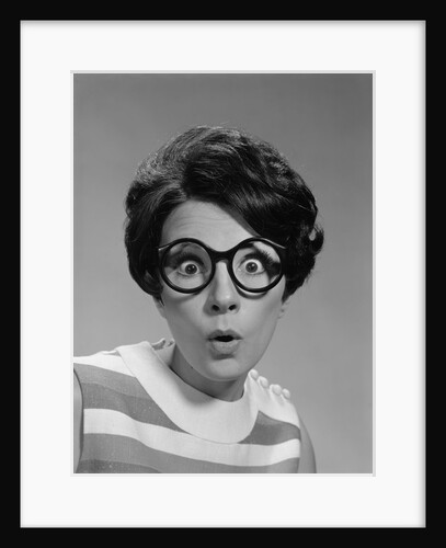 Portrait brunette wearing dark thick round eyeglasses with eyes wide open by Anonymous