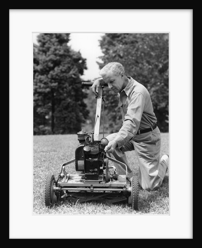 Elderly man in yard kneeling down to fix lawnmower by Anonymous