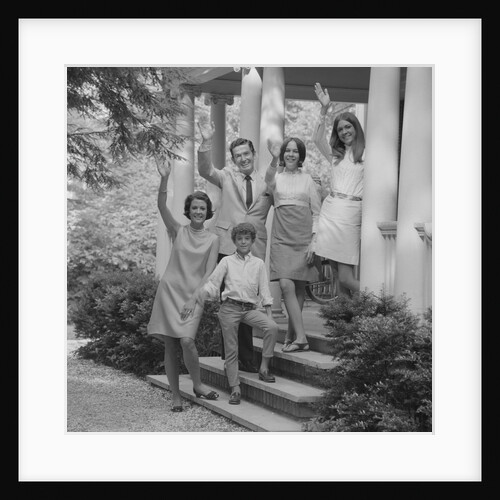 Family group of people standing on steps of house waving by Anonymous
