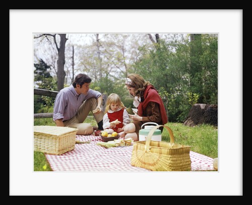 Family mother father girl spring picnic on checkered tablecloth by Anonymous