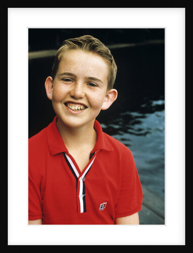 Portrait young boy in red shirt smiling by Anonymous