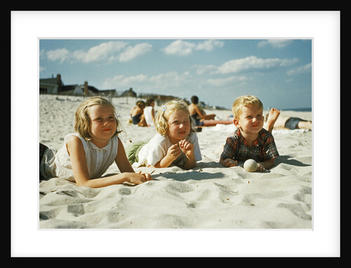 3 children lying on the beach at the jersey shore by Anonymous