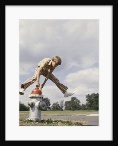 Boy jumping over fire hydrant by Anonymous