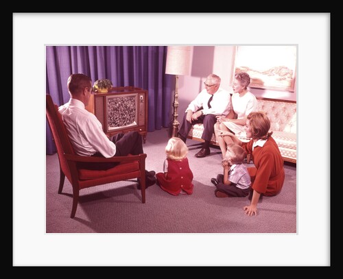 Three generation family watching television in living room by Anonymous