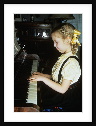 Little blond girl playing practicing the piano by Anonymous