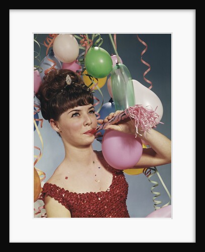 Woman blowing new years party noisemaker by Anonymous