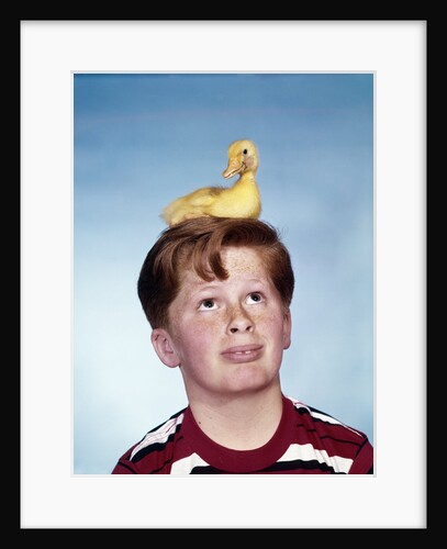 Boy with baby duckling sitting on top of his head by Anonymous