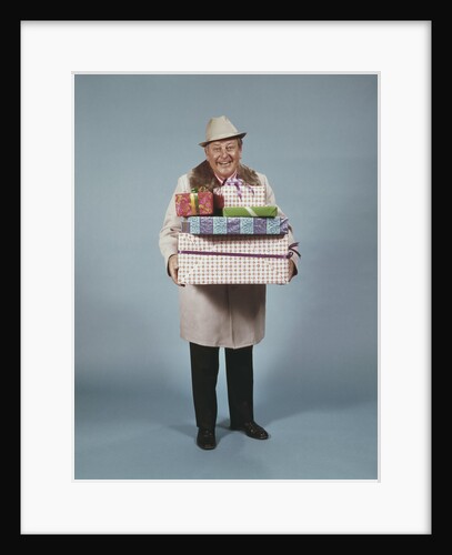 Smiling man hat coat carrying wrapped christmas presents by Anonymous