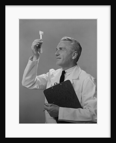 Man scientist studying test tube by Anonymous