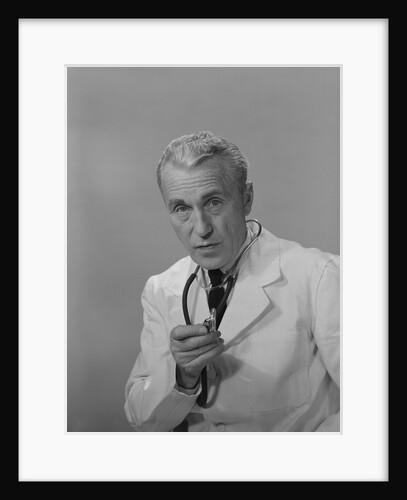 Male doctor holding stethoscope by Anonymous