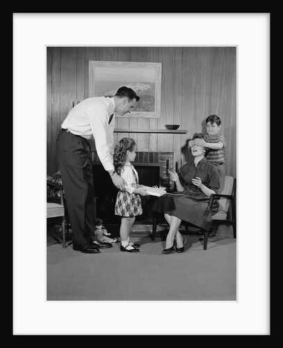 Family living room woman mother getting surprise gift from children daughter son husband by Anonymous