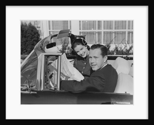 Husband wife man woman in automobile reading map by Anonymous