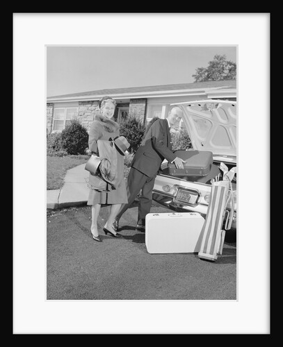 Senior man woman husband wife packing trunk with luggage by Anonymous