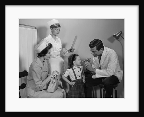 Mother sitting watching man pediatric doctor woman nurse checking on smiling little girl patient by Anonymous