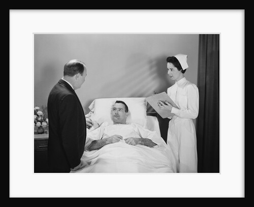 Man doctor woman nurse talking with male patient lying in hospital bed by Anonymous