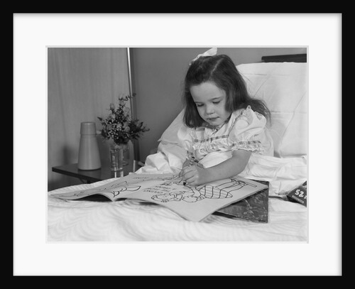 Little girl patient in hospital bed writing in coloring book by Anonymous